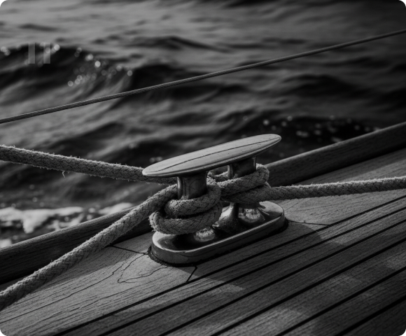Mooring rope secured to a cleat beside the water